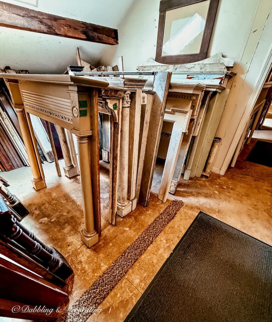 Collection of salvaged mantels lined up in all shapes, sizes, and ages at The Old House Parts Co.