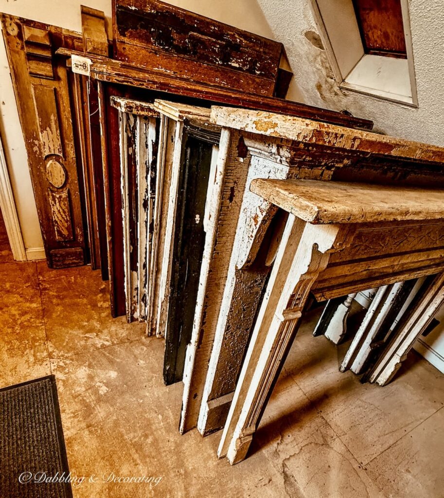 Collection of salvaged mantels lined up in all shapes, sizes, and ages at The Old House Parts Co.