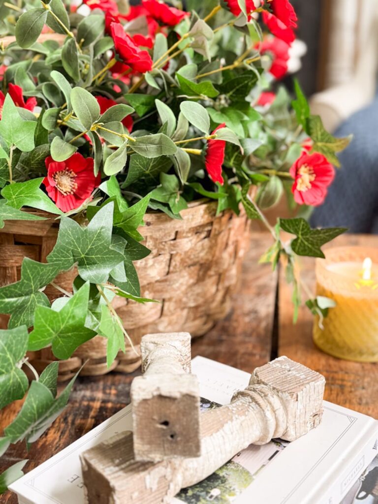 red summer flowers in a basket with white corbels.