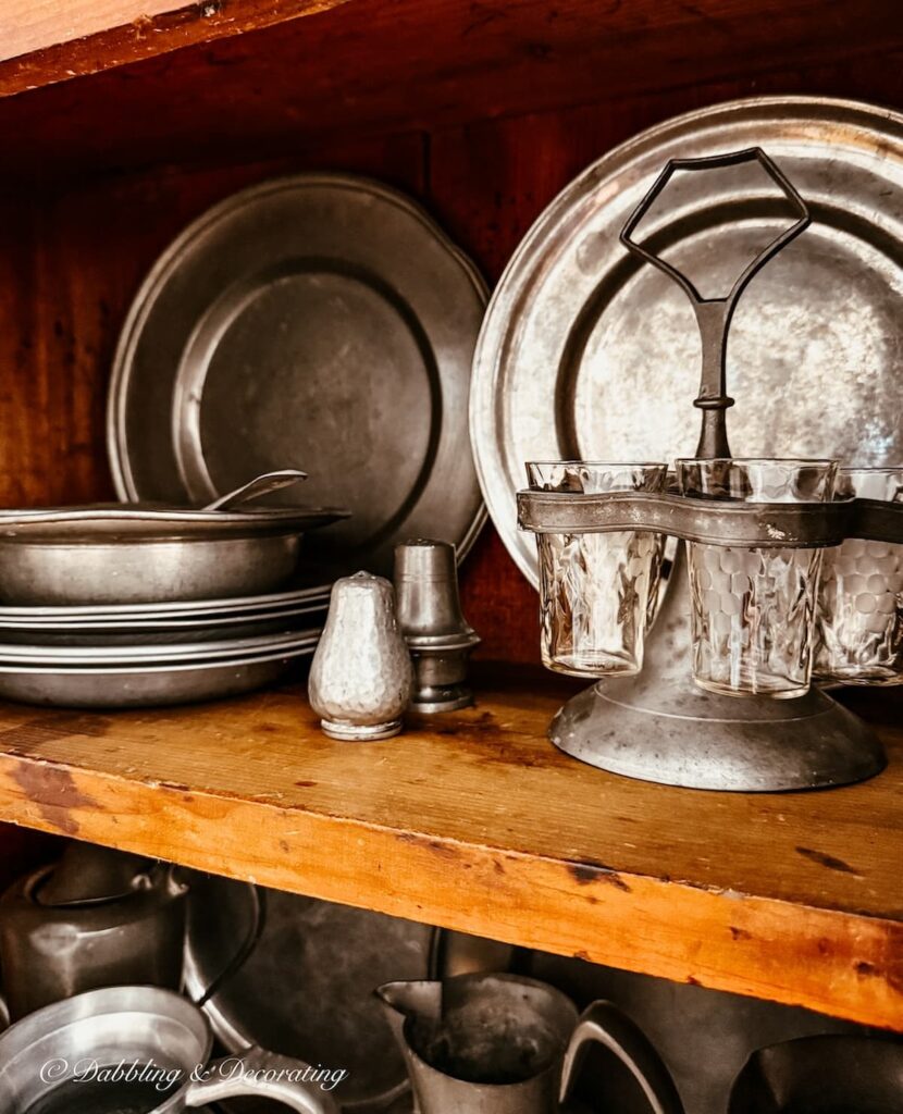 How to style an antique hutch with pewter using layers and Asymmetry style.