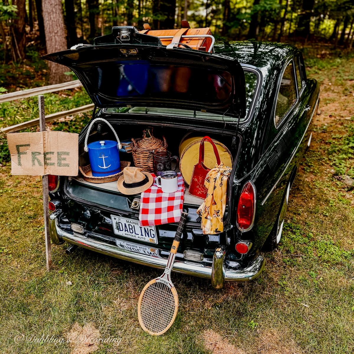 Antique VW Fastback with open trunk filled with thrifted finds on a thrift store road trip.