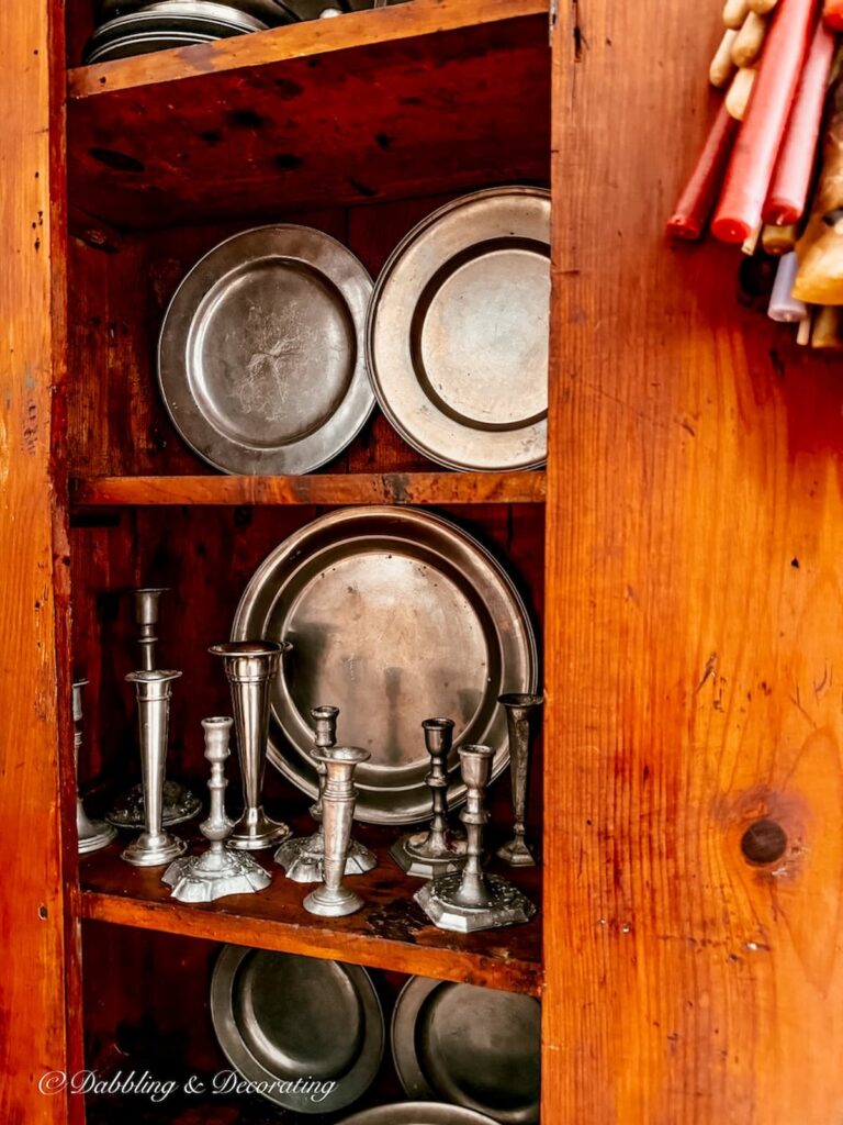 How to style an antique hutch with pewter using collections and layering pieces.