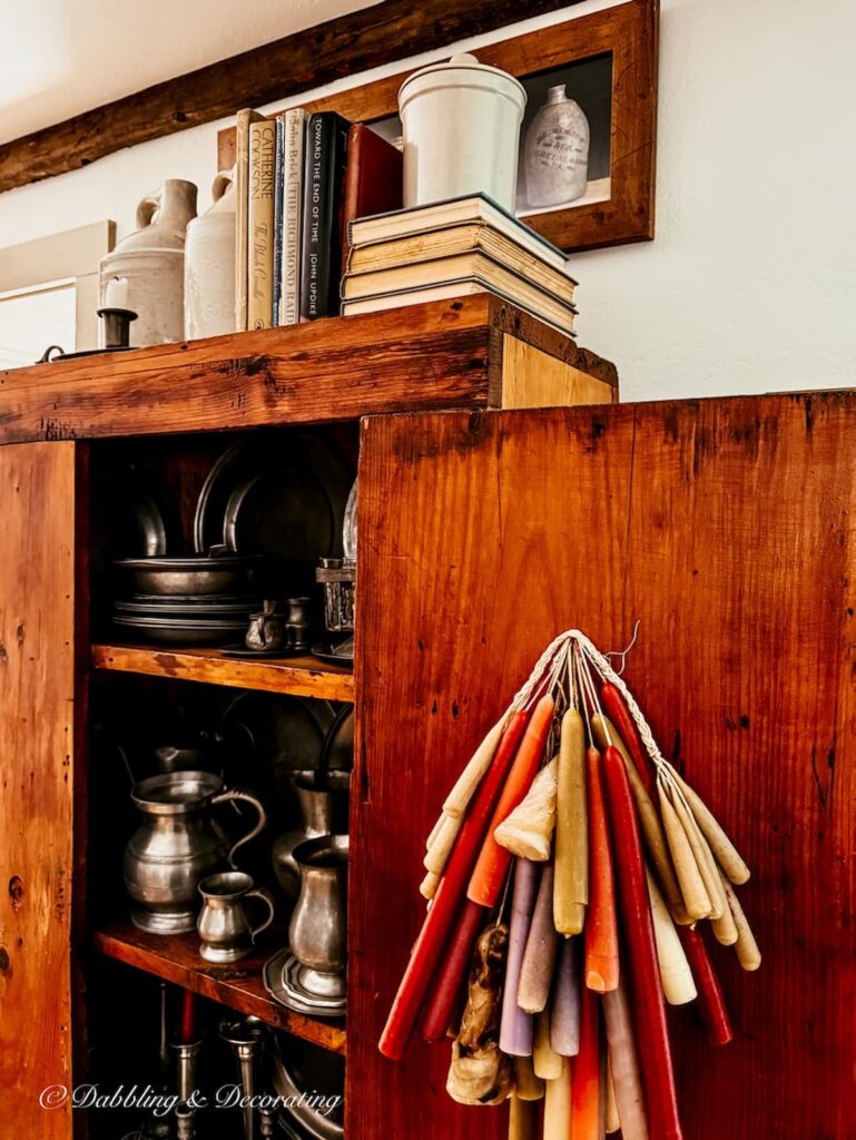 How to style an antique hutch with pewter in an Early American home dining room.