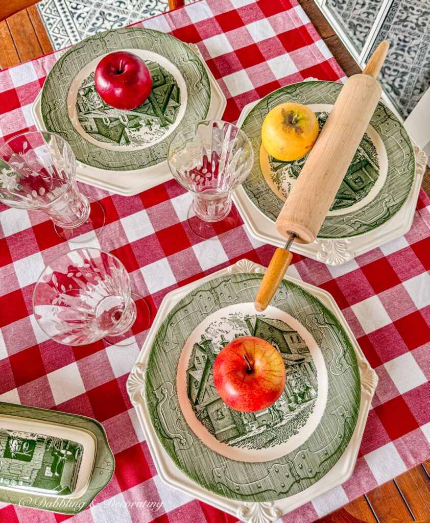 Vintage green and white Royal Colonial place settings on red gingham tablecloth in fall table decor.