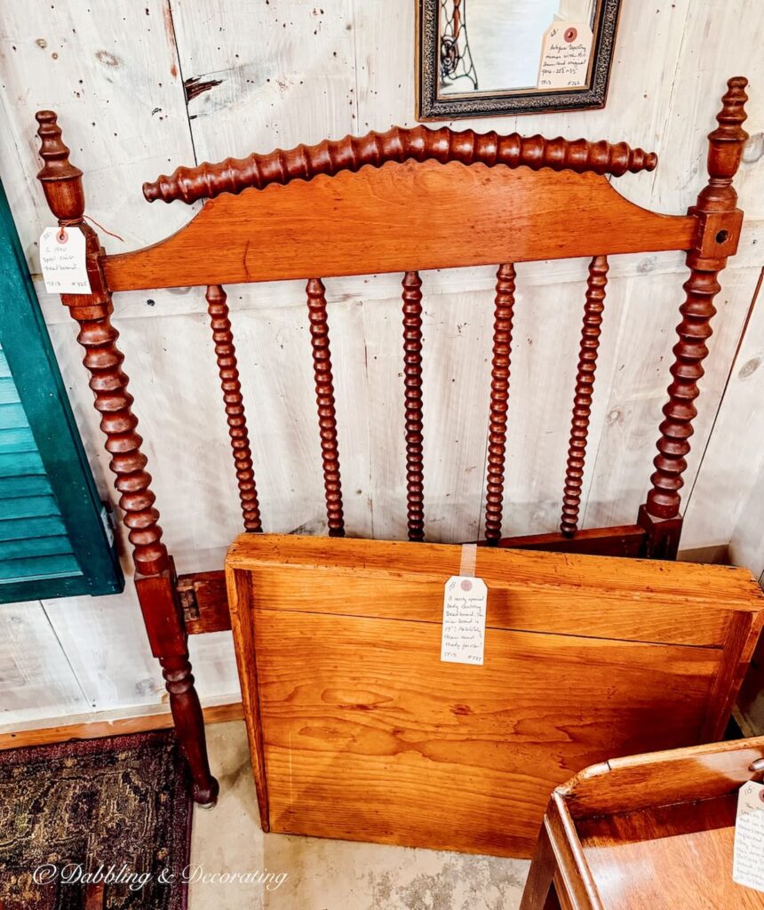 Antique spindle Jenny Lind bed headboard in antique store.