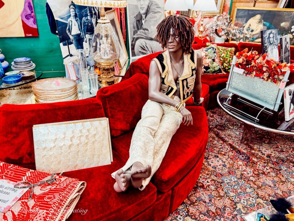 African American 60's styled mannequin on red velvet couch at the RS Butler's Trading Company in NH.