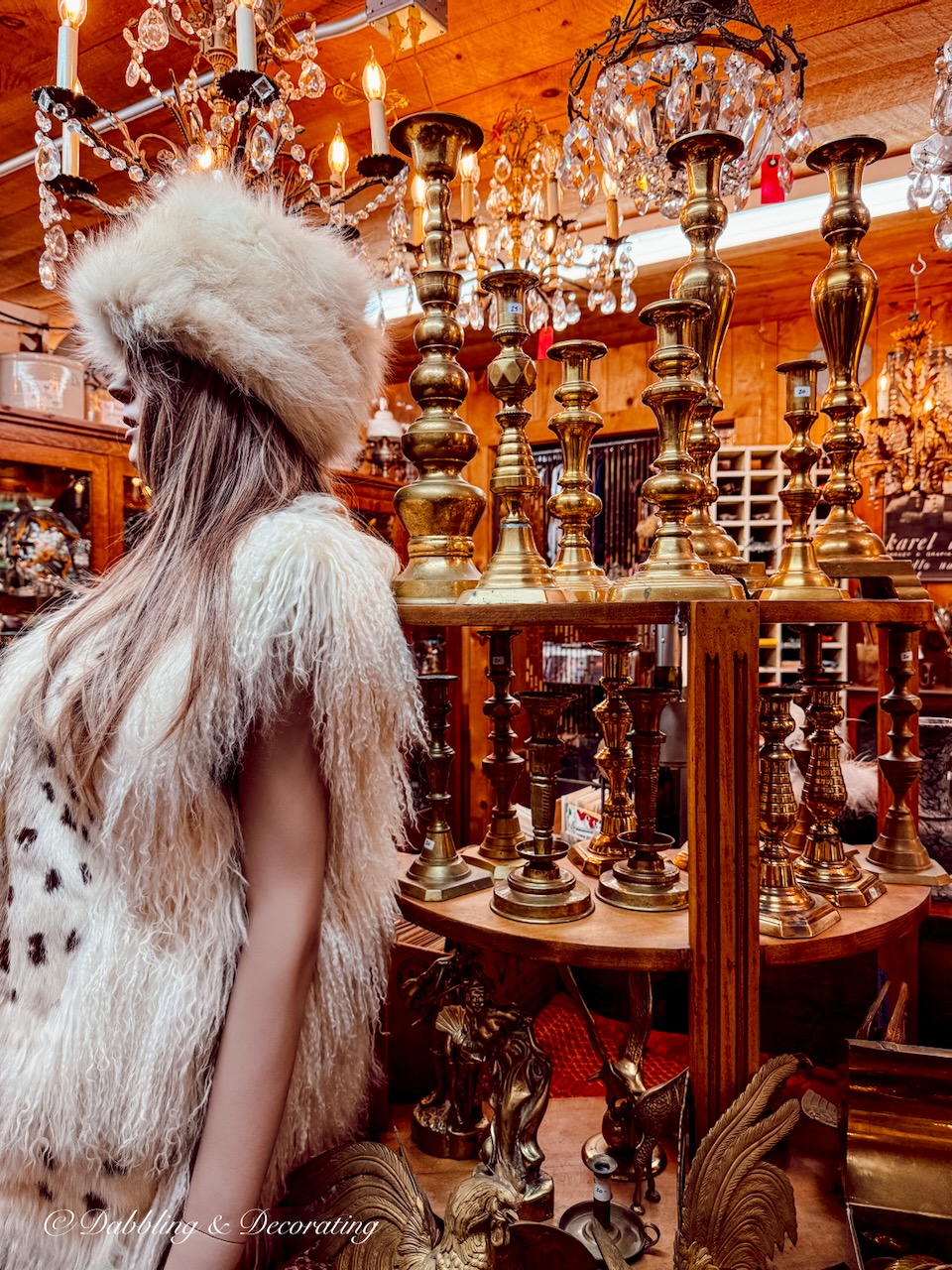 60's styled female mannequin with long blonde hair and fur hat and mink amongst brass vintage decor at RS Butler's Trading Company in New Hampshire.