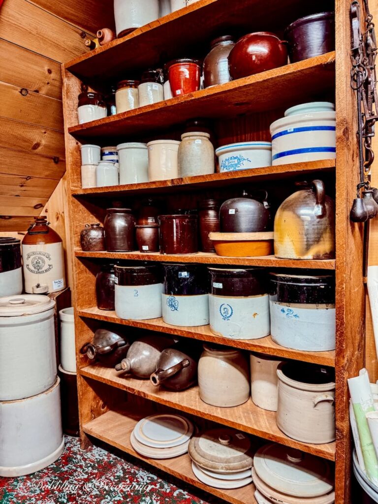 Shelves of vintage crocks lined up at RS Butler's Trading Company in New Hampshire.