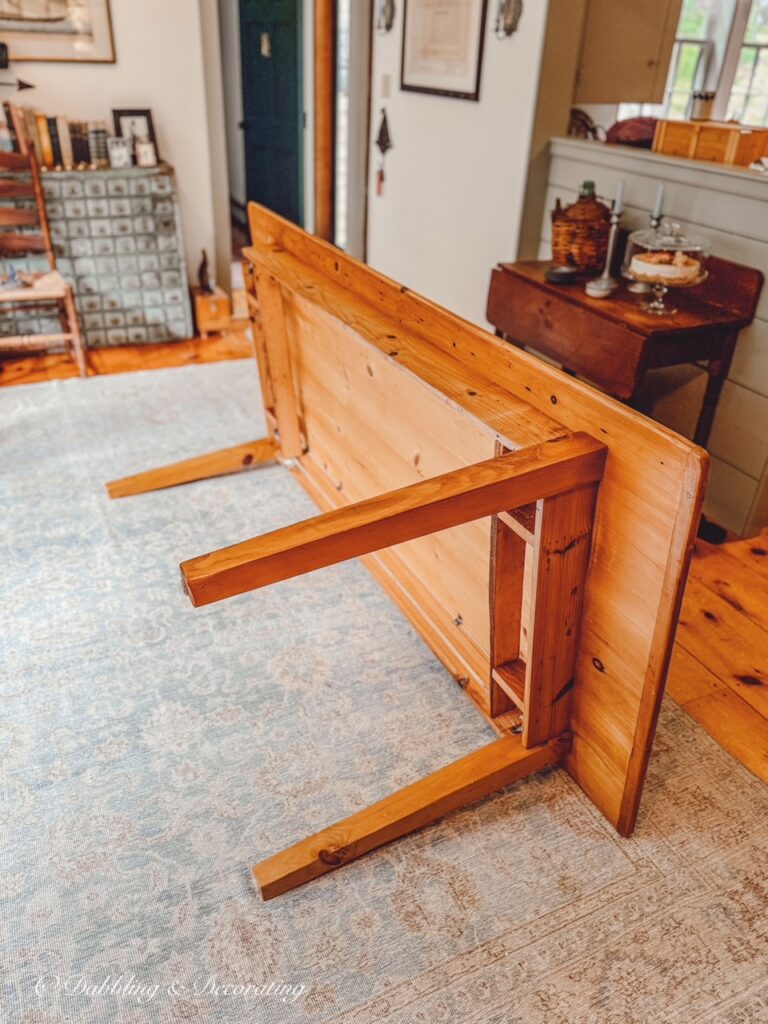 Vintage Rectangular wooden pine table on it's side being broken down in dining room. Round vs. Rectangular Dining Table: How We Created a Vintage-Inspired Gathering Space.