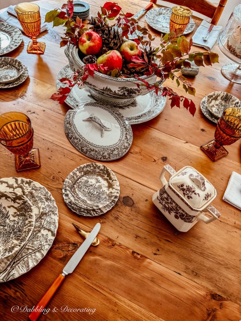 Brown and white vintage fall transferware centerpiece on round table in fall dining room decor.