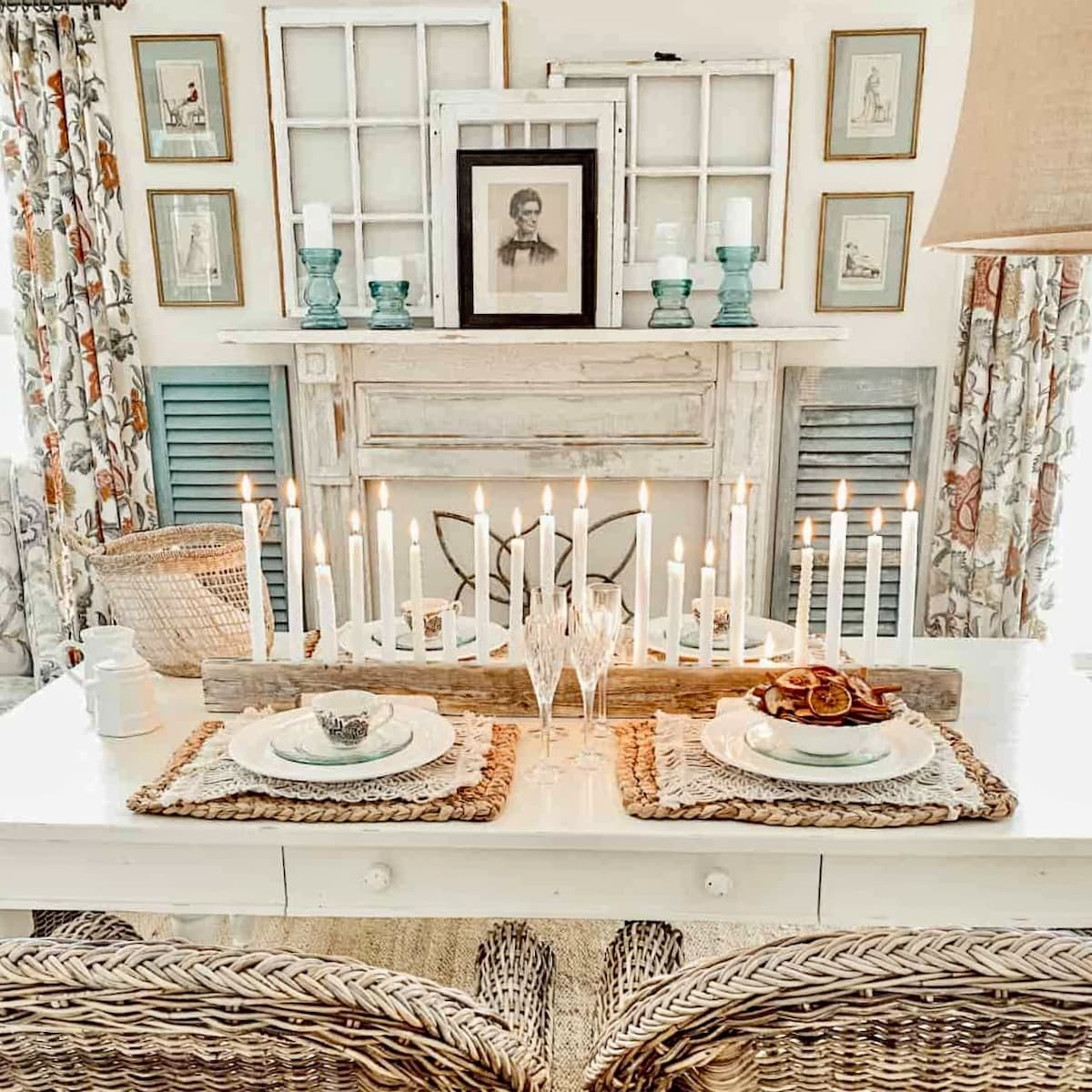 White rectangular farmhouse table in white styled dining room with wicker chairs and bench and candle centerpiece before transforming to a Scullery-Inspired Kitchen Workroom.