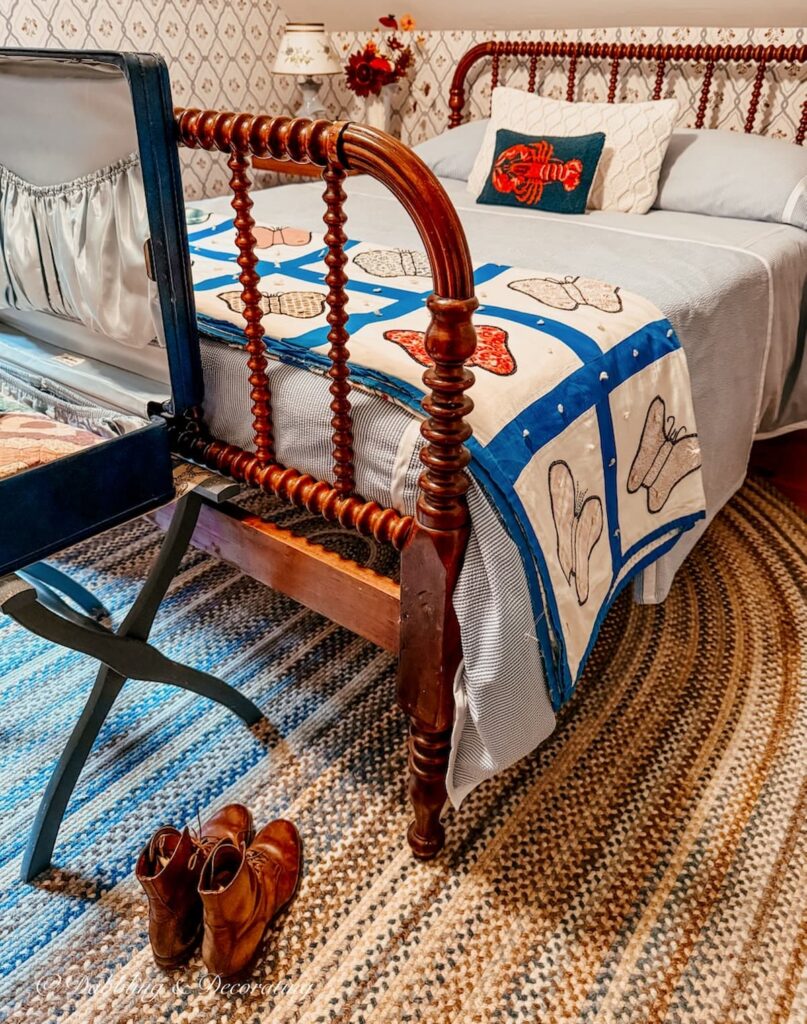 Antique Jenny Lind bed in small attic guest bedroom with fall decor ideas from Goodwill Northern New England.