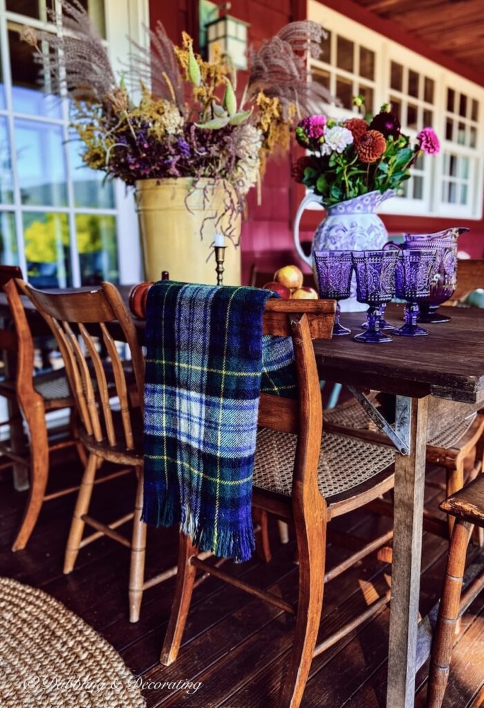 Thrifted Pendleton blanket on the back of a vintage wooden chair from Goodwill Northern New England fall decorating ideas.