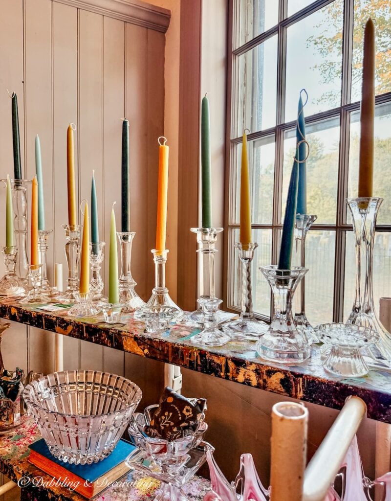 Crystal candlestick display with colorful tapers at Vintage and Vogue Market Display.