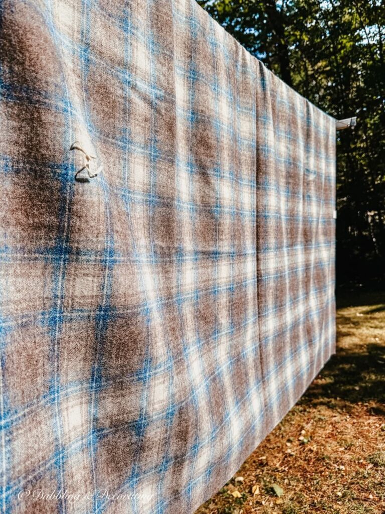 Vintage blue and brown Woolrich swatch on clothesline.