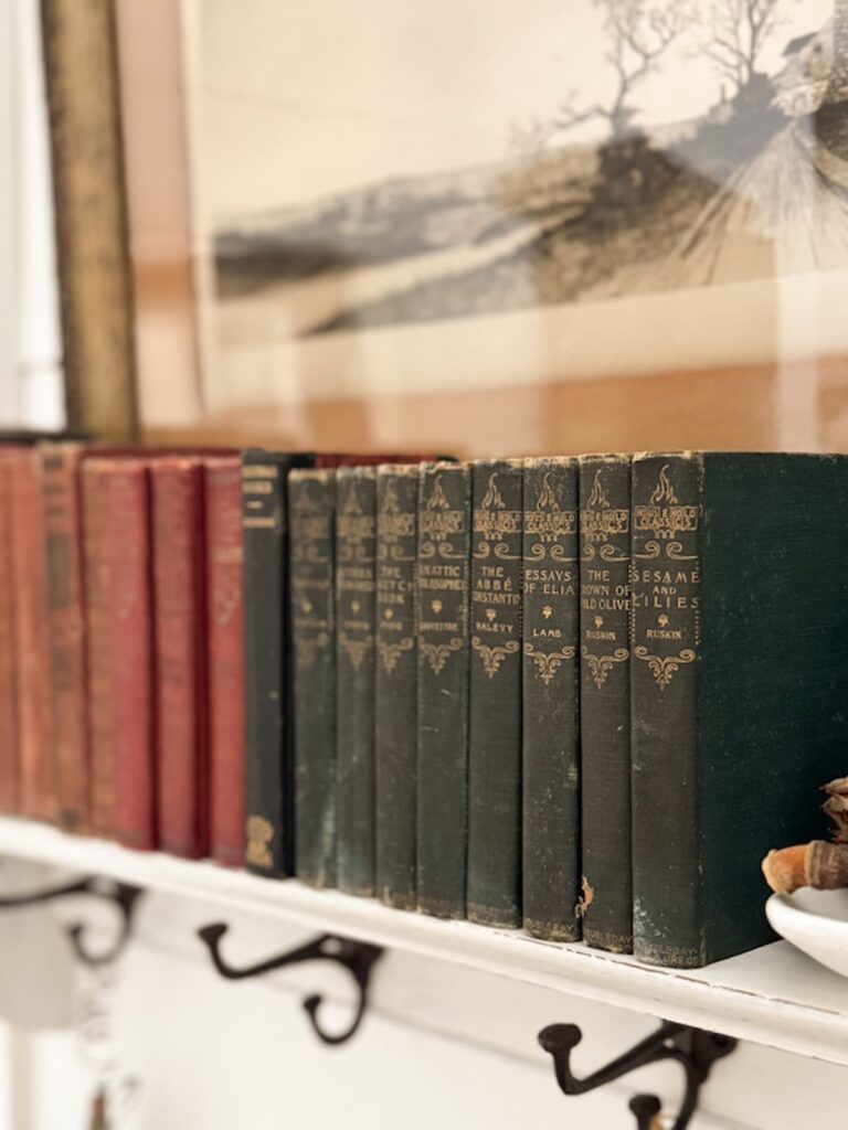 Antique book collection on wall shelf.
