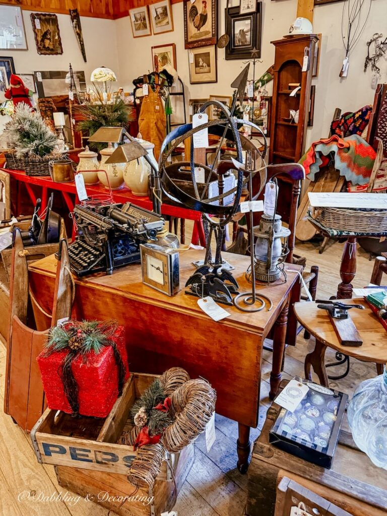 Large antique booth at Stone House Antique Center in Chester, VT filled with vintage decor collectibles.