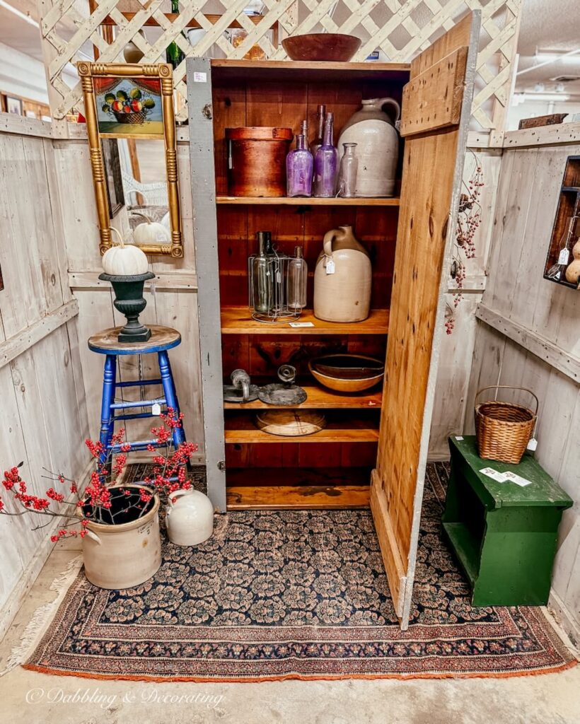 Vintage Ski lodge decor, snowshoes, wooden skis, toboggan inside an antique booth at Stone House Antique Center in Vermont.