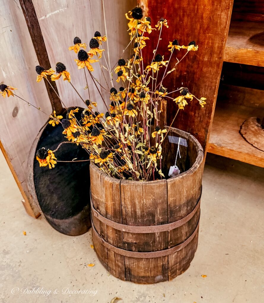 Wooden barrel filled with black eyed Susans in Thanksgiving vintage decor ideas.