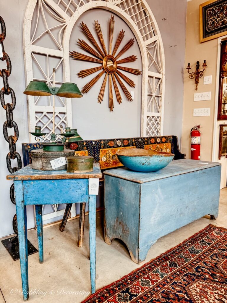 Antique blue trunk, bowl and side table in vendor display antiquing in the Berkshires.
