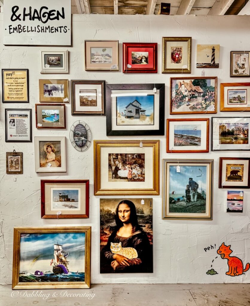 Wall of vintage paintings and pictures inside All That Jazz Antiques antiquing in the Berkshires.