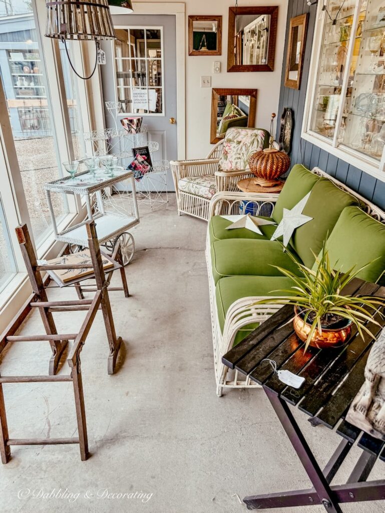 Outdoor furnishings in window at at Great Finds Antiques in Sheffield, Massachusetts antiquing in the Berkshires.