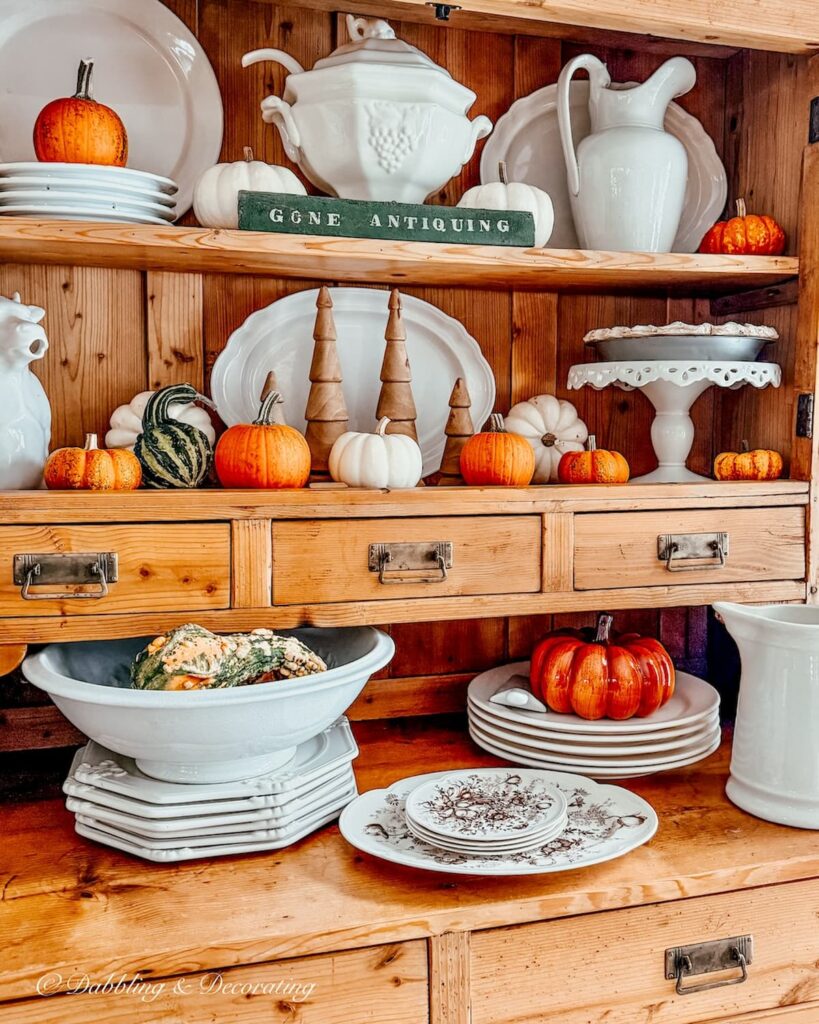 Antique pine hutch with white ironstone displays with pumpkins and ghourds and a set of brown and white transferware platter and dishes found antiquing in the Berkshires.