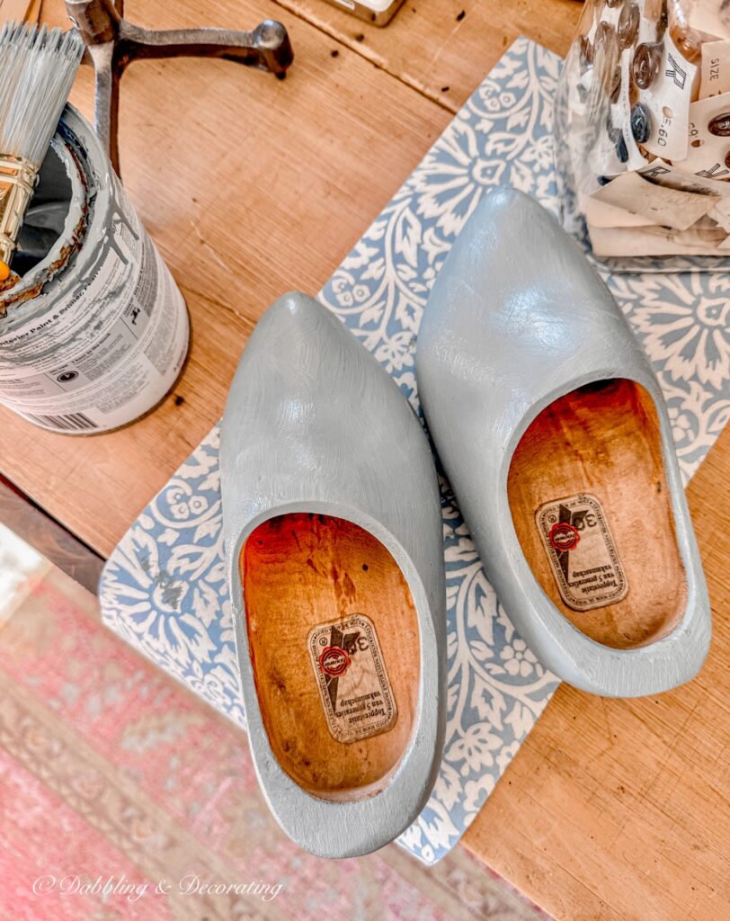 Pair of Dutch wooden clogs with one coat of blue paint, left unfinished inside.