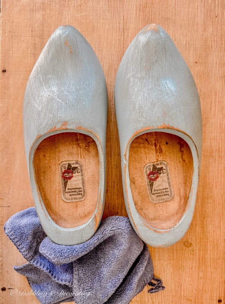 Pair of Dutch wooden clogs painted in blue, sanded, with antique glaze applied.