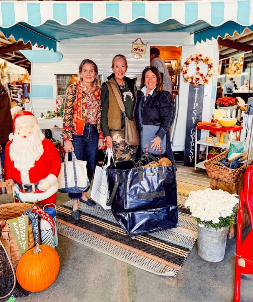 Three women at Vintage Market Days Vermont thrifting for vintage Christmas decor ideas.
