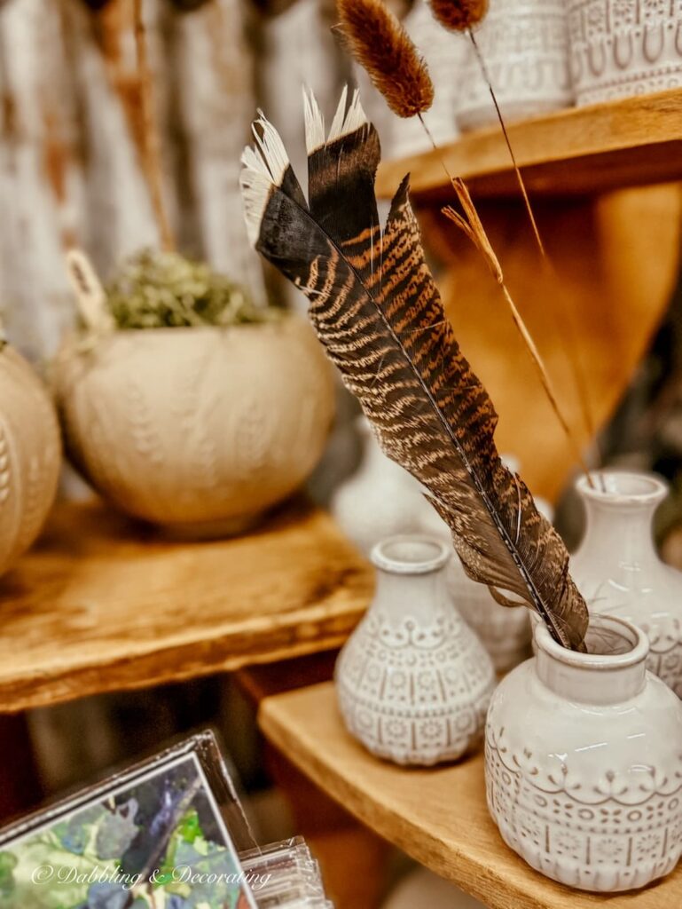 Pheasant feather in small pitcher at Vintage Market Days Vermont.