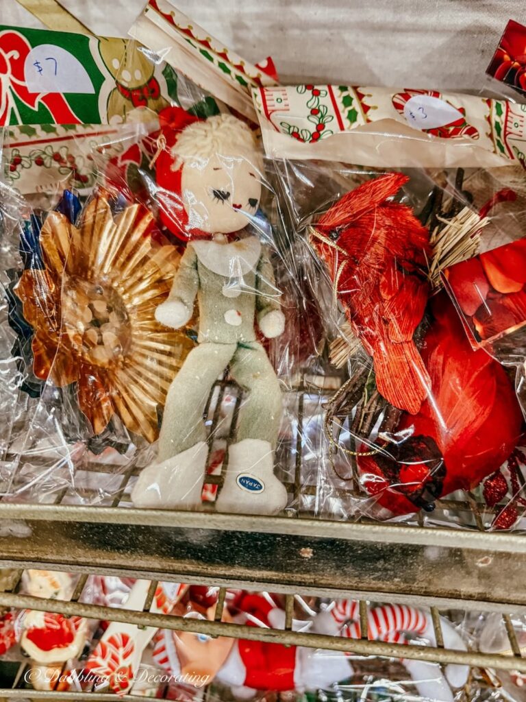 Retro Christmas ornaments in plastic grab bags at a vintage New England market for vintage Christmas decor ideas.