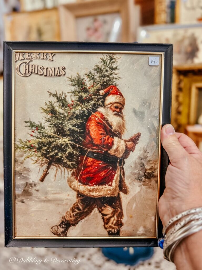 Vintage Christmas decor with a framed picture of Santa Claus and a Christmas Tree.