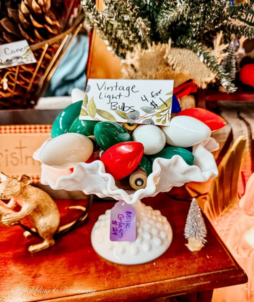 Retro red, green, white, Christmas bulbs displayed in a milk glass bowl as vintage Christmas decor.