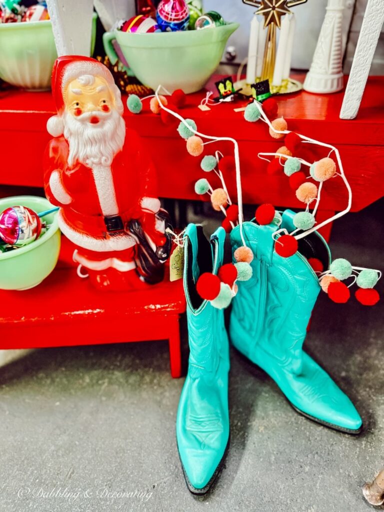 Retro aqua cowboy boots and a red plastic Santa Clause in Vintage Christmas decor ideas.