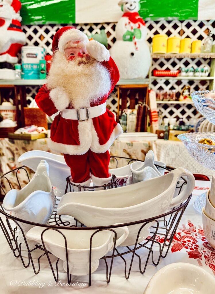 Santa Claus figurine displayed amongst ironstone gravy boats.