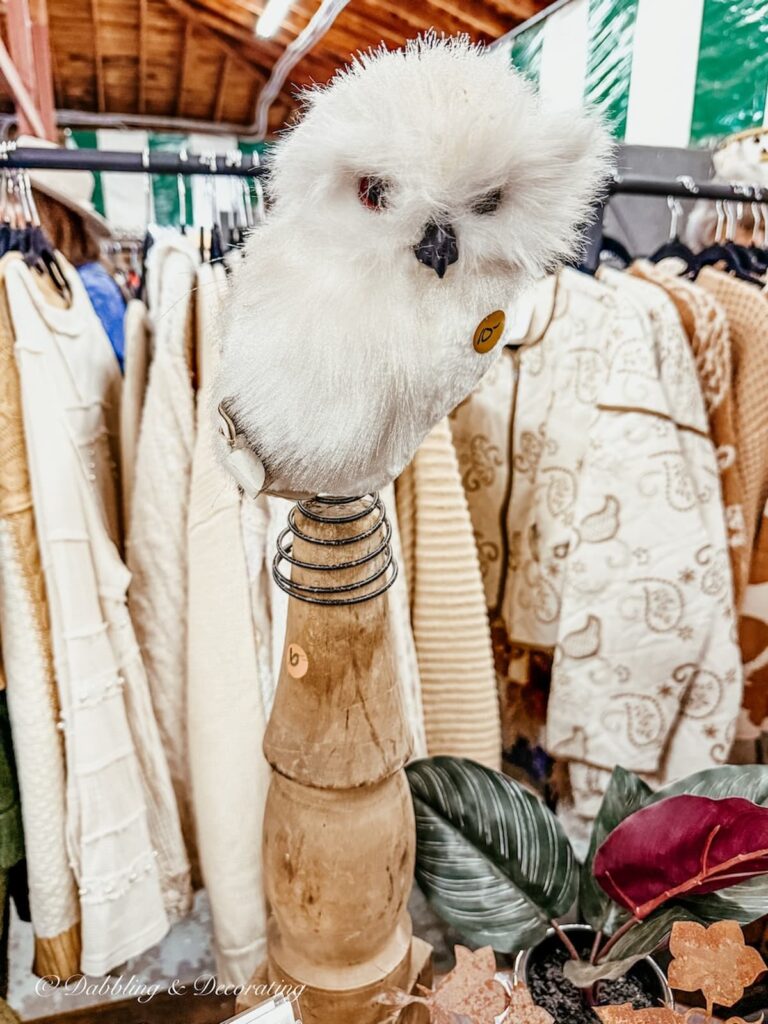 White fluffy owl on wooden finial at vintage market days Vermont.