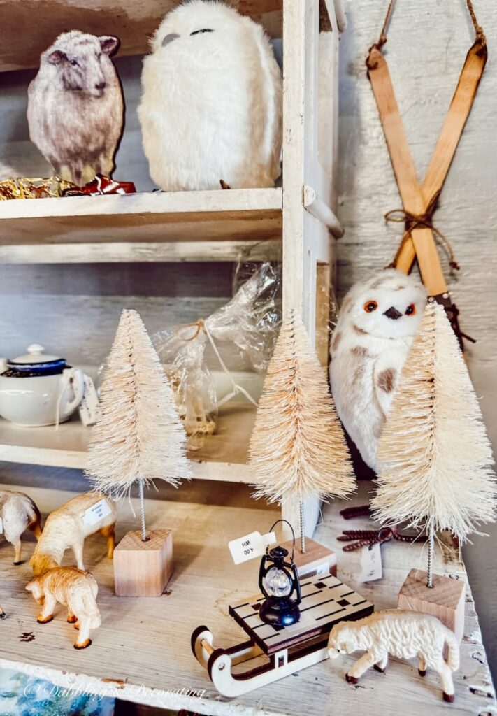 Winter white owls and farm animal figurines for vintage Christmas decor at a vintage market in New England.