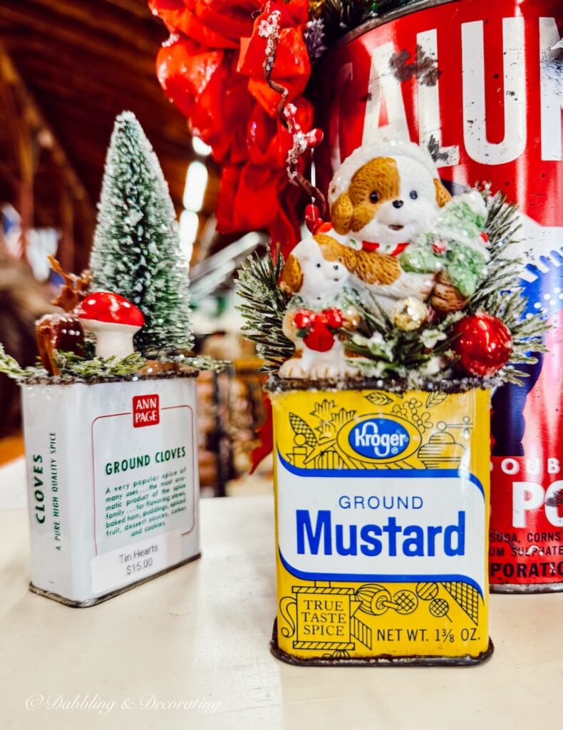 Small vintage spice tins decorated for Christmas at Vintage Market Days.