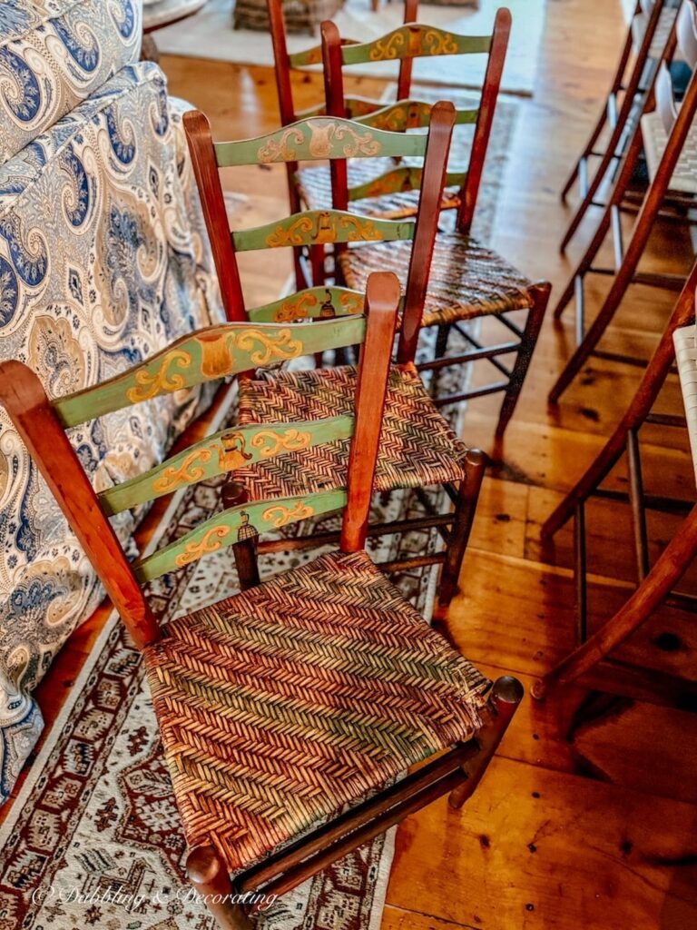 Vintage home decor gifts, four ladder back chairs with cane seating and Pennsylvania Dutch inspired details.