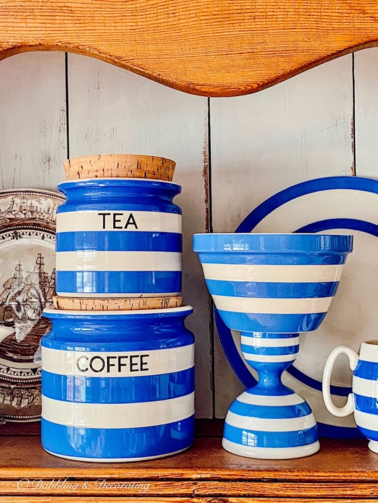 Collection of vintage Cornishware displayed in hutch.
