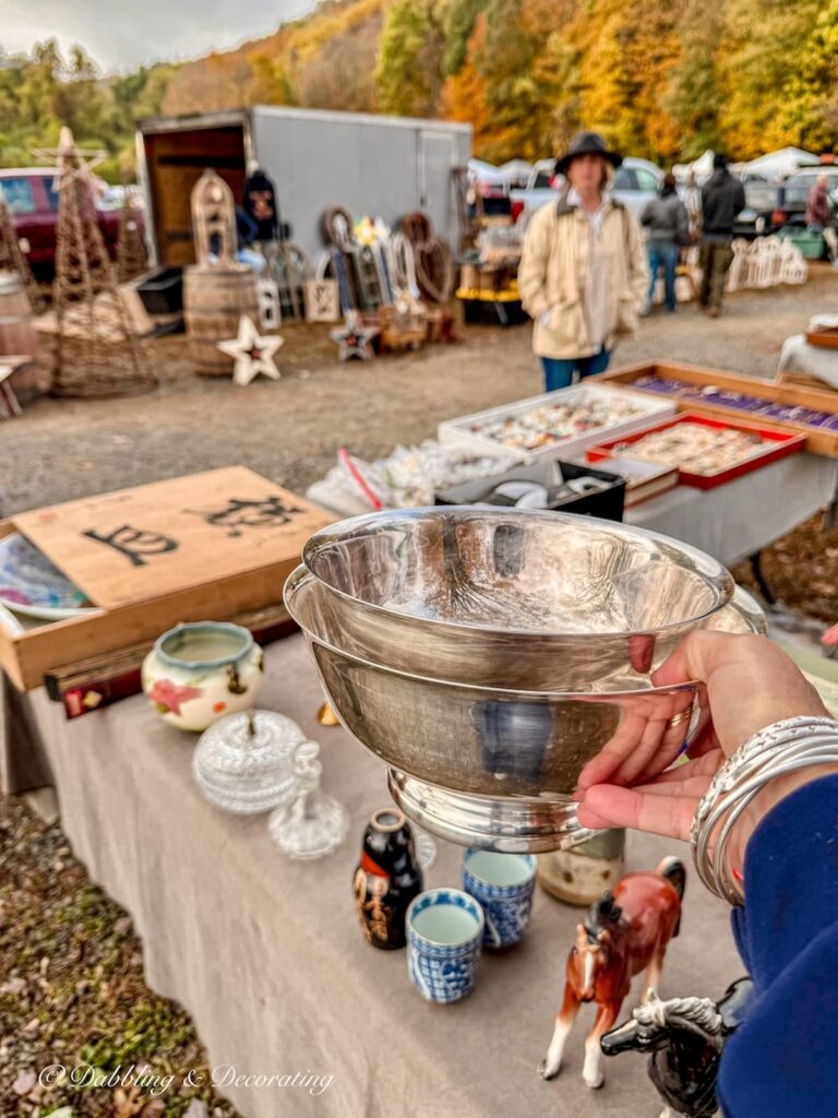Two silver bowls in hand at Elephant Trunk's flea market during peak fall foliage in October.