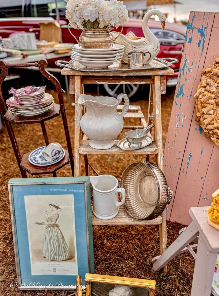 Vendor antique booth with blues and pink hues at Elephant Trunk's Flea market.