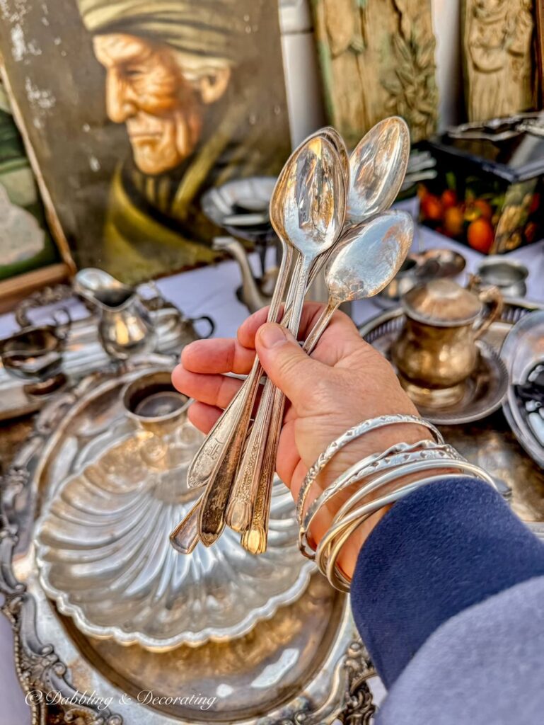 Vintage silver bar spoons in  hand at Elephant Trunk Flea Market.