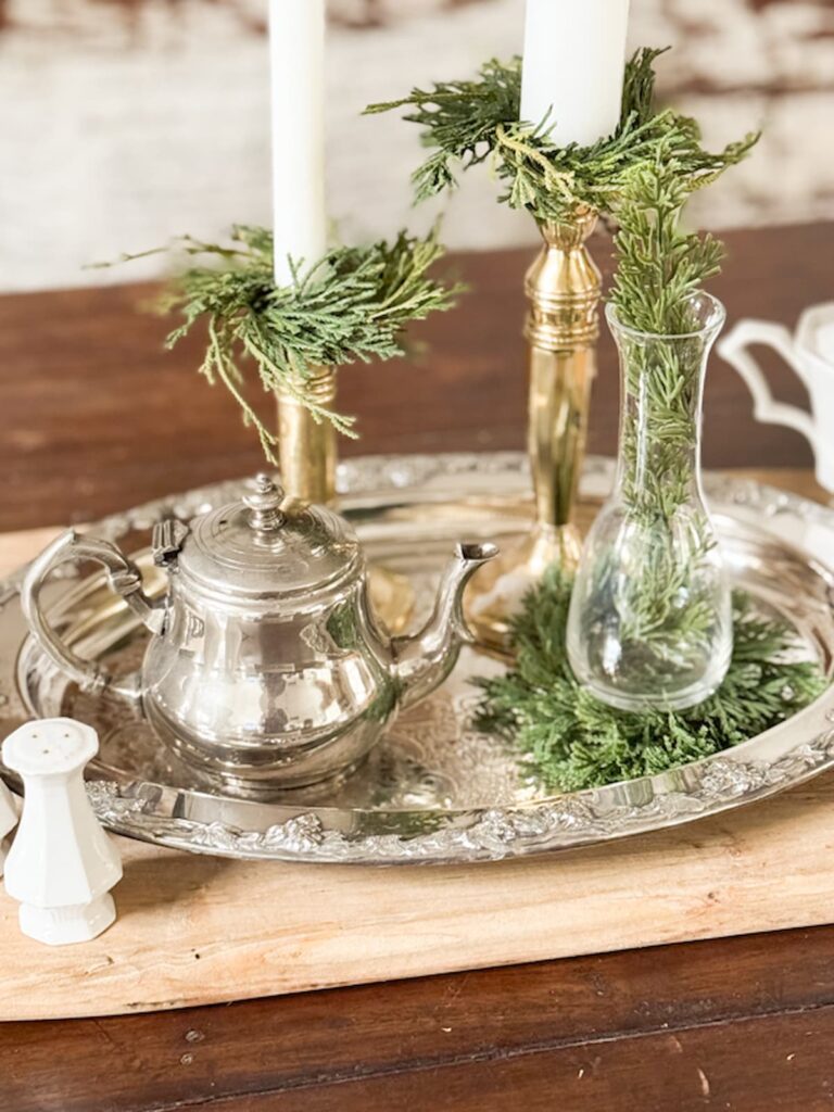 Vintage silver tray with home decor accessories.