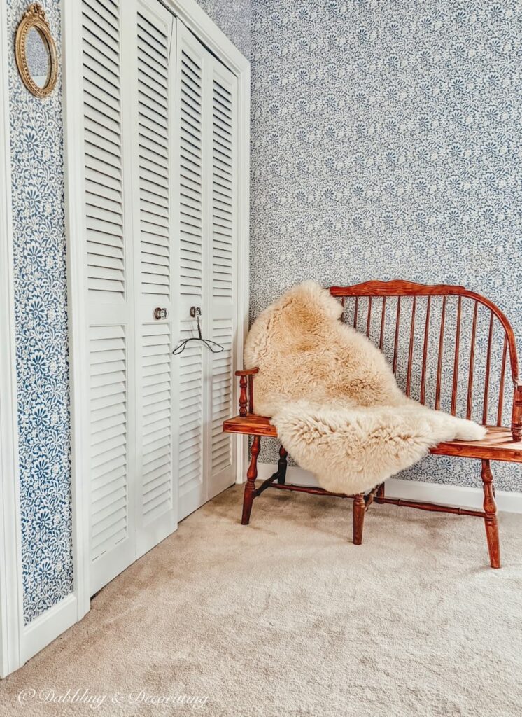 Sheepskin decor ideas on a wooden bench in a bedroom corner, Scandinavian inspired.