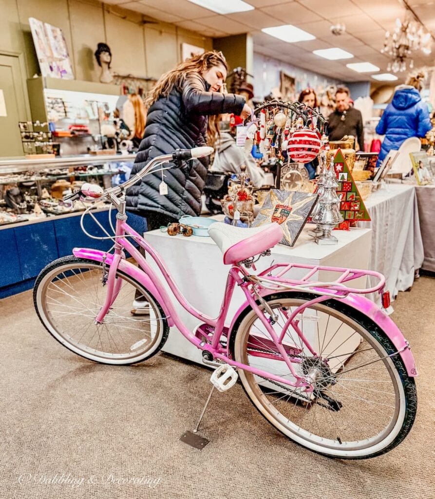 Old pink bike inside the The Second Show Thrift Shop on Warren St. Hudson, NY.