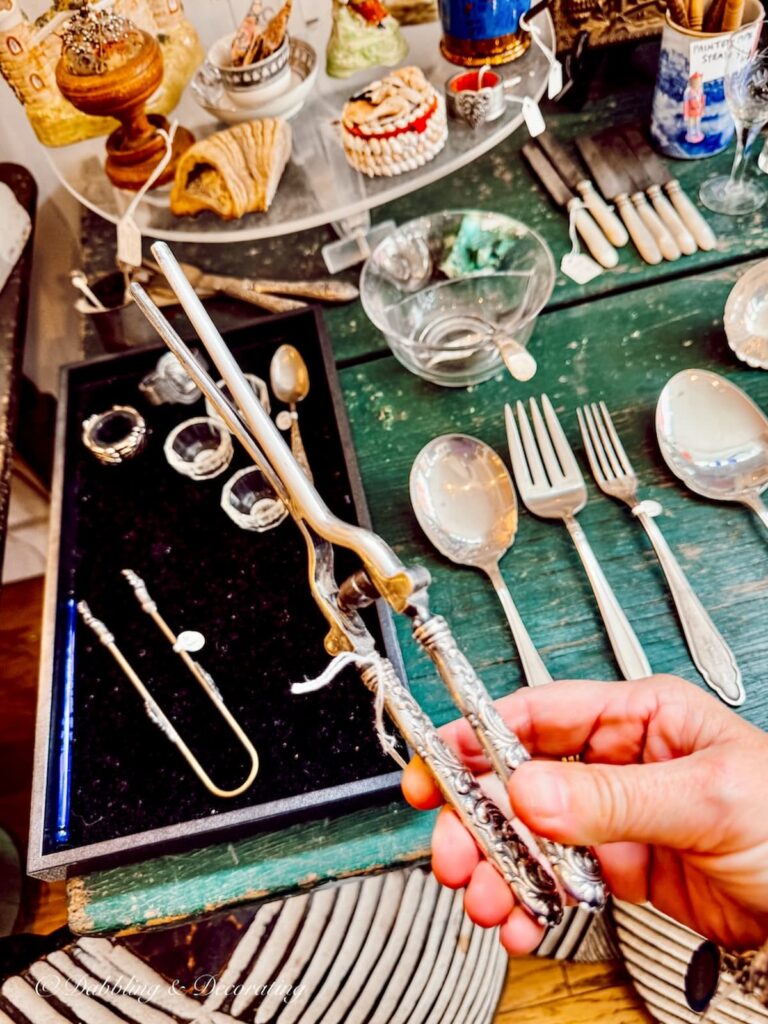 Antique silver curling iron in hand at the White Whale Limited on Warren Street in Hudson, NY.