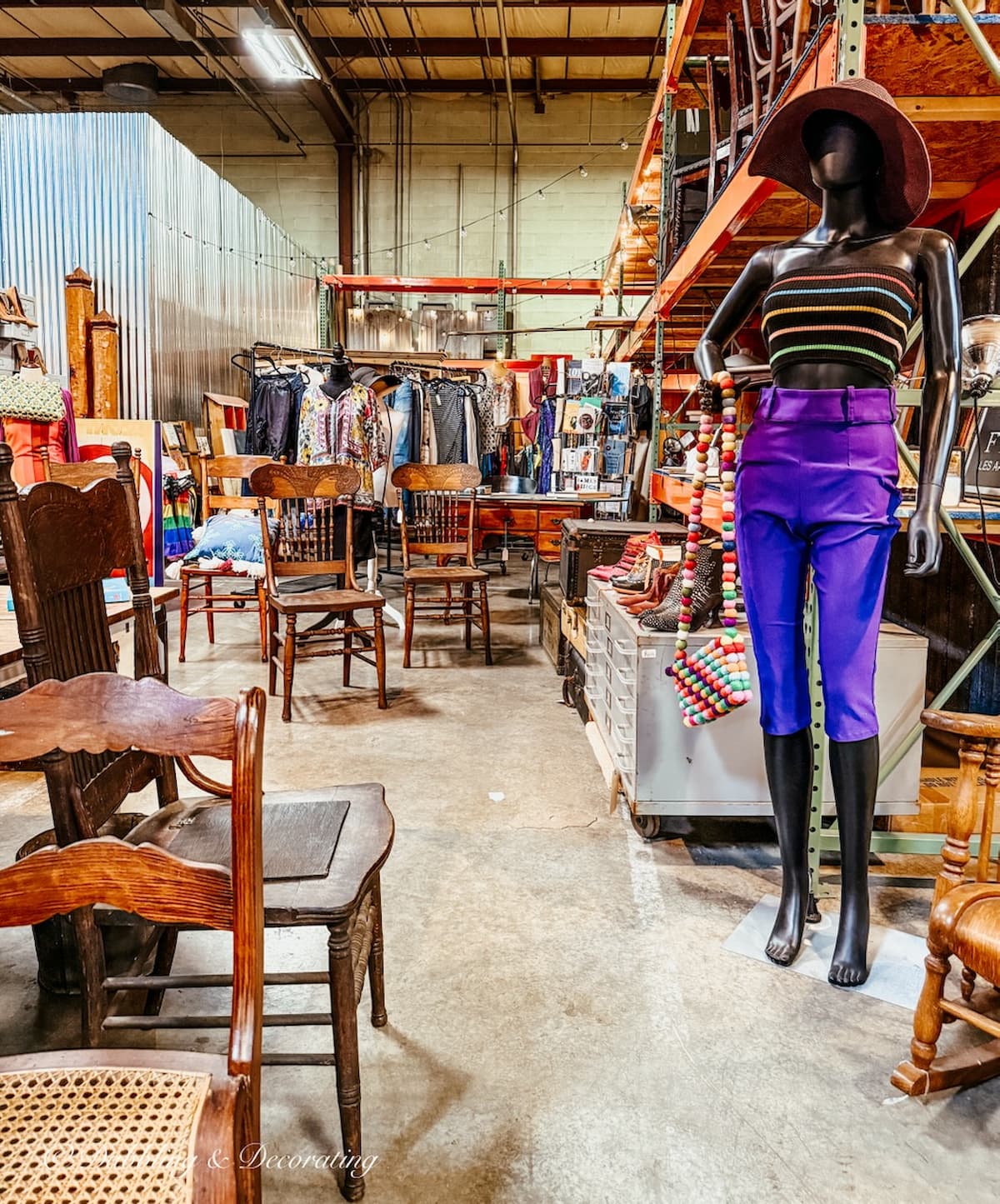 Mannequin dressed in 70s style purple clothing in eclectic vintage style vendor displays at The Antique Warehouse Hudson, NY.