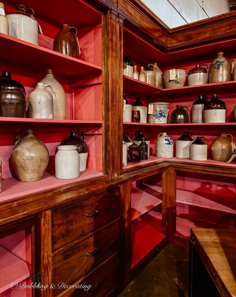 Antique crock displayed on pink wooden shelving at The Antique Warehouse Hudson NY